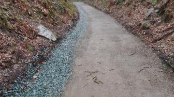 Smooth Tamar trail path after being repaired with steep natural banks either side